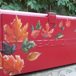 Red Bread Box with Fall leaves hand painted blowing in the wind up and over the box