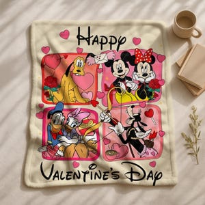 A Valentine's Day-themed blanket featuring characters from Disney's animated films, including Donald Duck, Minnie Mouse, Pluto, and Mickey Mouse, surrounded by hearts and flowers.