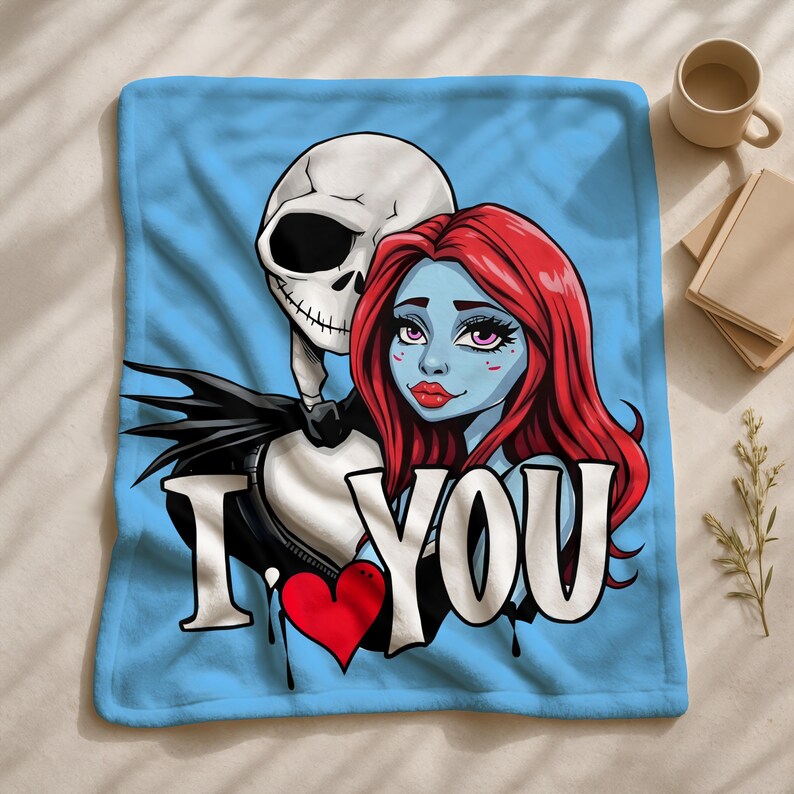 A blue blanket with a graphic design featuring a female character with red hair and a skeleton, along with the text "I Love You" and a heart symbol.