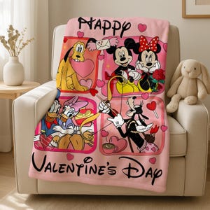 A pink blanket with a collage of Disney characters and the text "Happy Valentine's Day" is displayed on a chair.