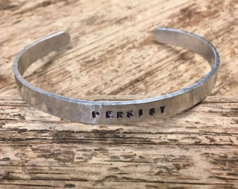 Hand Hammered and Stamped 0.25 Inch Wide Aluminum Bracelet with the Word "Persist"