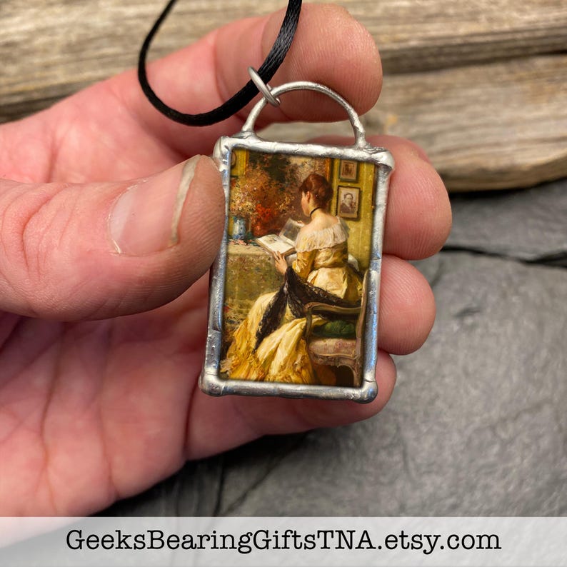 Pendant with vintage Victorian artwork and inspiring quote about books by Geeks Bearing Gifts. image 2