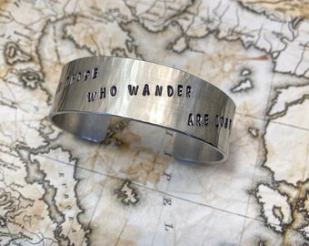 Not all those who wander are lost. 3/4 inch hammered aluminum cuff bracelet with star and moon accents and Tolkien quote.