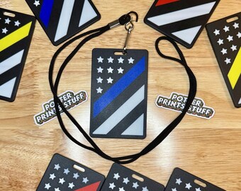 May include: Black ID badge with a blue stripe, white stripe, and stars design, with a black lanyard. Other badges feature red and yellow stripes. The text "POTTER PRINTS STUFF" is also visible.