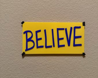 Believe Wall, Desk, or Door Sign - 4x7 inches, Adhesive Strip and Stand Included