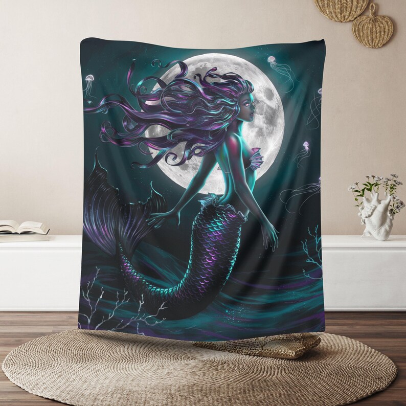 May include: A tapestry featuring a mermaid with long, flowing purple hair and a teal tail. The mermaid is swimming in front of a full moon with a dark blue background.