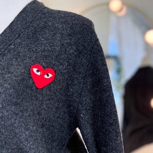 May include: A set of three ceramic mugs with a speckled, matte finish. The mugs are in shades of cream, light gray, and dark gray. Each mug has a simple, minimalist design, perfect for coffee or tea.