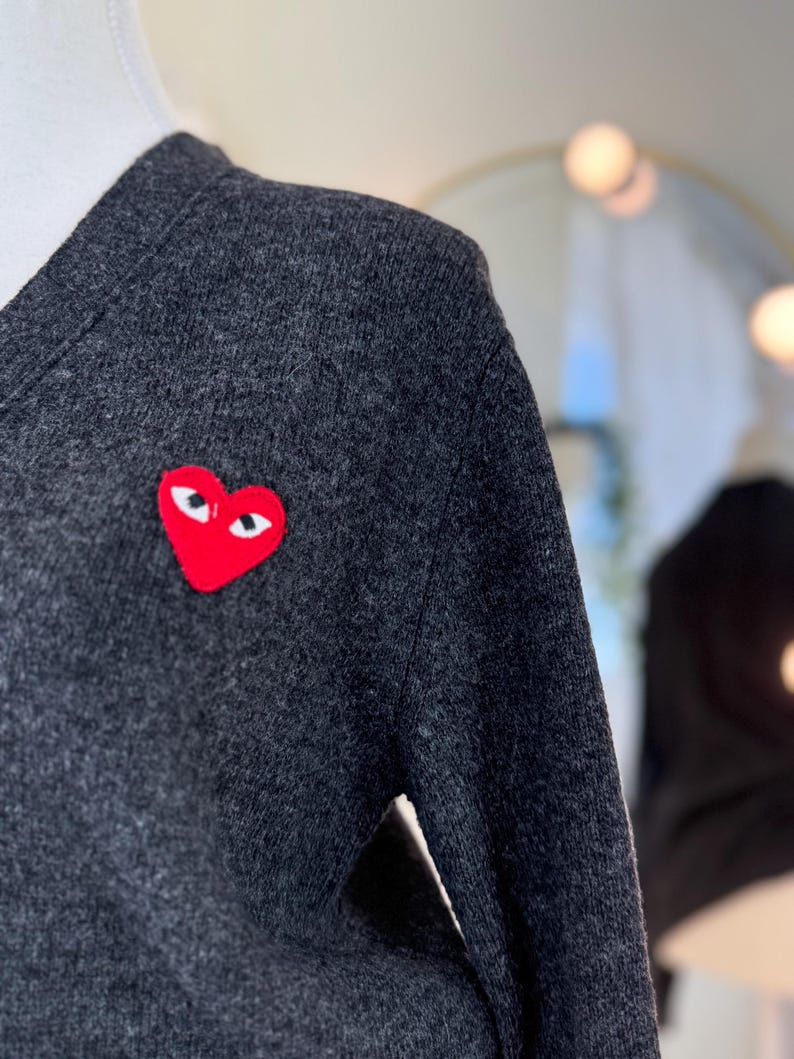 May include: A set of three ceramic mugs with a speckled, matte finish. The mugs are in shades of cream, light gray, and dark gray. Each mug has a simple, minimalist design, perfect for coffee or tea.