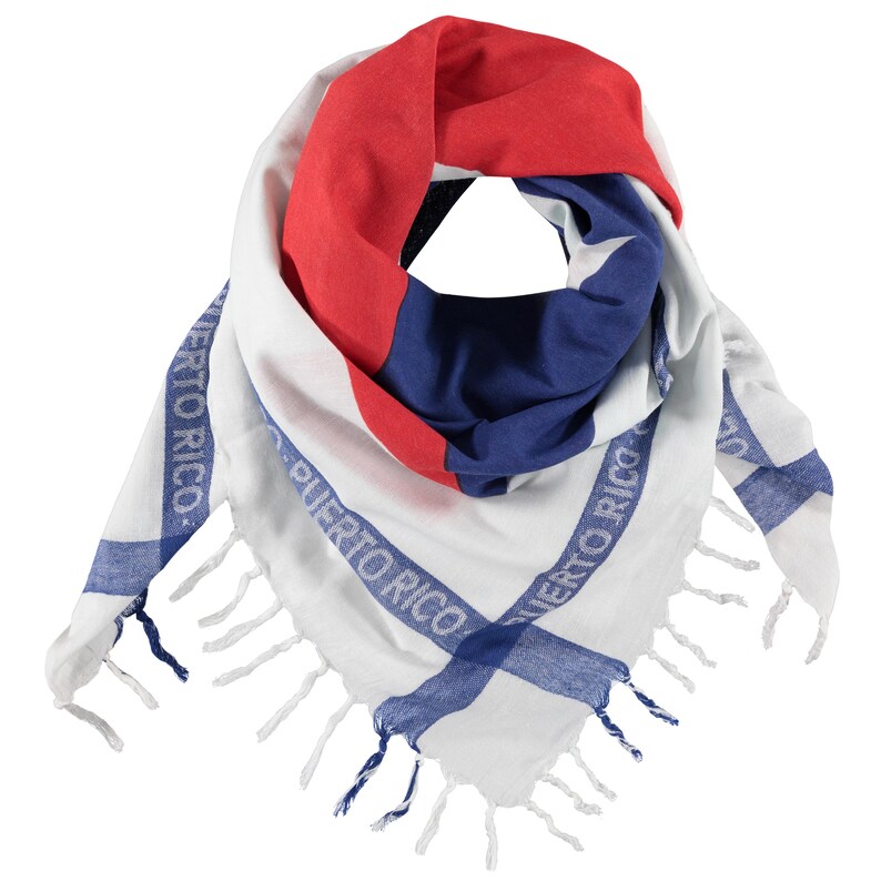 May include: A triangular scarf featuring a white base with red and blue sections. The fabric displays the text "PUERTO RICO" printed in blue along the edges. The scarf is finished with white and blue fringe tassels along the bottom border.