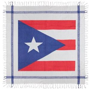 May include: A square textile featuring the Puerto Rican flag design with a central white star on a blue triangle and red and white horizontal stripes. The border consists of a blue band with the repeated text PUERTO RICO and white fringe.
