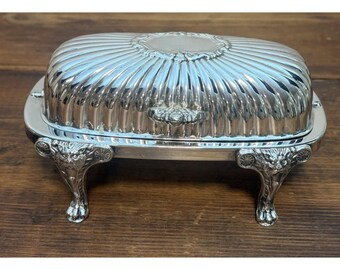Mantequera antigua de plata FB Rogers con tapa enrollable y patas de león ornamentadas, interior de vidrio.