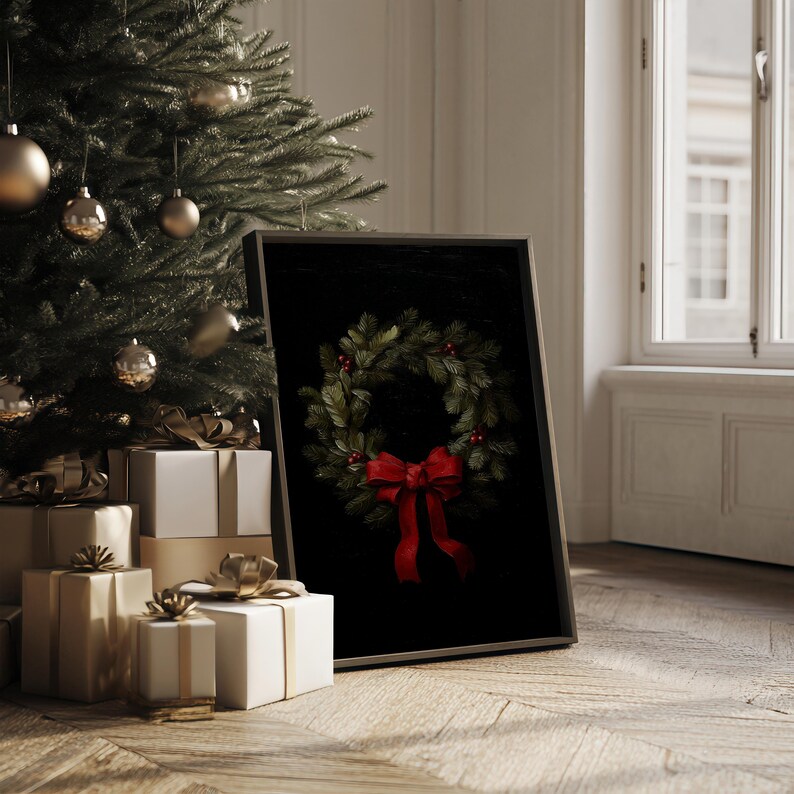 In a sumptuous dark wood frame, a festive wreath painting with a red bow exudes cozy holiday charm beside an elegantly decorated Christmas tree and stylishly wrapped gifts, capturing timeless winter decor and old money vibes.