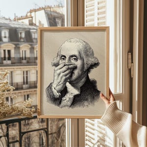 A whimsical vintage sketch of George Washington humorously pinching his nose is framed in sleek natural wood, perfect for adding funny bathroom art to any space. Bathed in soft, natural light, this piece brings a touch of funny decor to vintage settings.