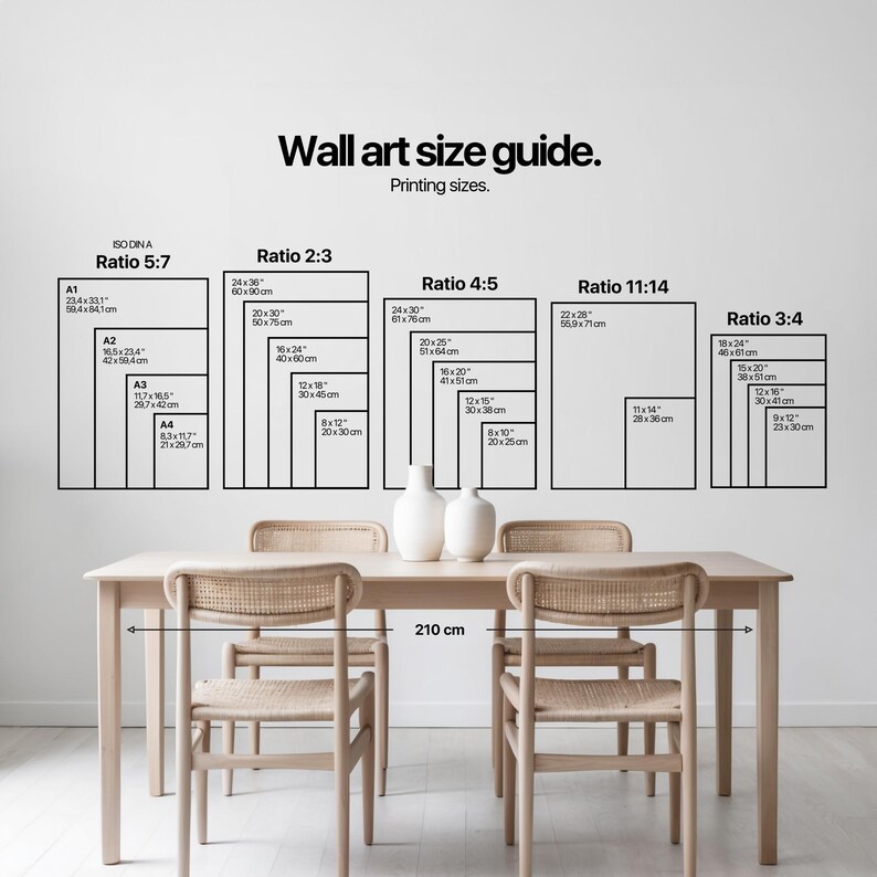 A clean, minimalist dining area showcases a natural wood table with woven chairs, styled with two white ceramic vases under soft lighting. This setting elegantly frames a wall art size guide, embodying the essence of light academia decor.