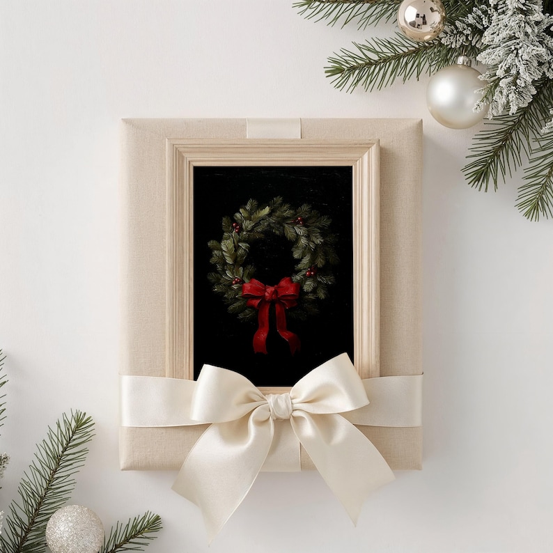 A beautifully wrapped beige frame showcases a festive wreath with a red bow, surrounded by evergreen branches and silver ornaments, evoking a cozy holiday atmosphere perfect for dark academia decor.