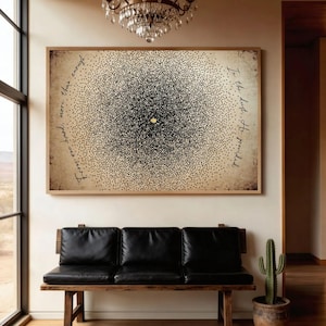 May include: A rectangular wall art piece featuring a dense, circular cluster of black dots on a beige, textured background. A single gold dot sits at the centre. Cursive black text reads: "For one hand, more than enough" and "In the dust, He provided."