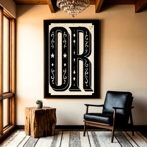 May include: A rectangular wall art piece featuring the large black letters OR in a decorative serif font on a cream background. The letters are embellished with white filigree swirls, stars, and diamond shapes, all enclosed within a dark frame.