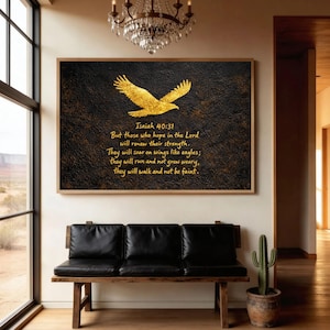 May include: A framed wall art piece featuring a gold eagle design on a textured black background. The artwork includes the text "Isaiah 40:31" and a Bible verse. The frame is a warm brown color.