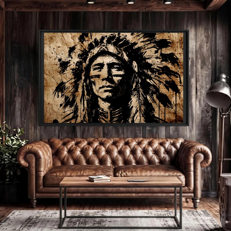May include: A rectangular framed wall art piece featuring a high-contrast black ink illustration of a person wearing a traditional feathered headdress. The artwork is set against a textured, weathered tan background with visible ink splatters.