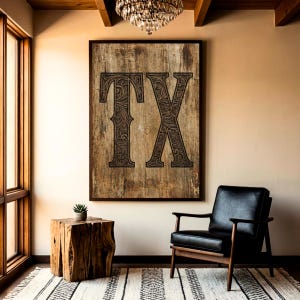 May include: A rectangular wall art piece featuring the letters TX in a dark, intricate, floral-engraved style set against a weathered, light brown wood-grain background, enclosed within a thin, dark brown frame hanging on a plain wall.