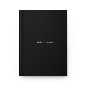 May include: A black notebook featuring the words "Voice Memos" in white lettering. The notebook has a minimalist design, with a plain black cover. The text is centrally aligned, creating a clean aesthetic.