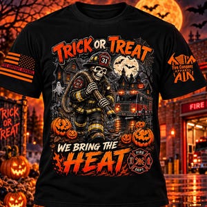 May include: A black short-sleeve t-shirt featuring a graphic of a skeleton firefighter holding a hose in front of a fire truck and haunted house. The text reads "TRICK OR TREAT" and "WE BRING THE HEAT" with orange and red accents throughout.