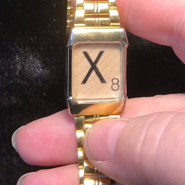 1980’s adjustable gold tone watchband with an “X”