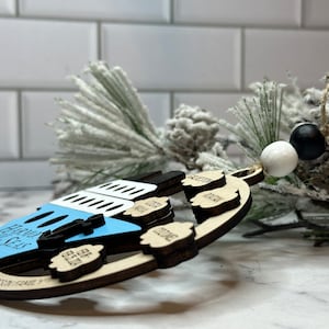 This beautifully crafted customized cruise ship ornament is the perfect way to commemorate your nautical adventures. Handmade with care, this charming ornament can be personalized with your family name, ship name, ports and cruise dates.
