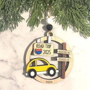 Add a touch of charm to your Christmas tree with our laser engraved wood road trip ornament. Handcrafted with love, this unique piece captures the essence of adventure. Perfect for travel enthusiasts and wanderlust souls! A wonderful gift for anyone who loves hitting the open road. We can add up to 7 locations on this ornament to customize this to your favorite adventure. Order yours today!