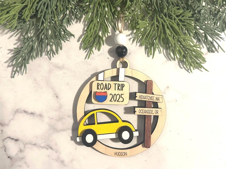 Add a touch of charm to your Christmas tree with our laser engraved wood road trip ornament. Handcrafted with love, this unique piece captures the essence of adventure. Perfect for travel enthusiasts and wanderlust souls! A wonderful gift for anyone who loves hitting the open road. We can add up to 7 locations on this ornament to customize this to your favorite adventure. Order yours today!