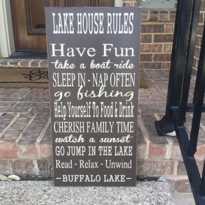 Custom wood sign measures approx. 11 1/4 x 23 inches and states: 

Lake House Rules
Have Fun
Take A Boat Ride
Sleep In - Nap Often
Go Fishing
Help Yourself To Food & Drink
Cherish Family Time
Watch A Sunset
Go Jump In The Lake
Read - Relax - Unwind