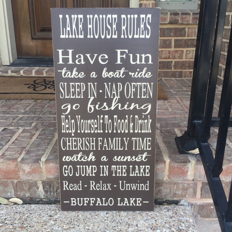 Custom wood sign measures approx. 11 1/4 x 23 inches and states: 

Lake House Rules
Have Fun
Take A Boat Ride
Sleep In - Nap Often
Go Fishing
Help Yourself To Food & Drink
Cherish Family Time
Watch A Sunset
Go Jump In The Lake
Read - Relax - Unwind