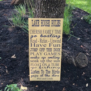 Custom wood sign measures approx. 11 1/4 x 23 inches and states: 

Lake House Rules
Have Fun
Take A Boat Ride
Sleep In - Nap Often
Go Fishing
Help Yourself To Food & Drink
Cherish Family Time
Watch A Sunset
Go Jump In The Lake
Read - Relax - Unwind