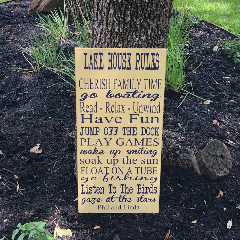 Custom wood sign measures approx. 11 1/4 x 23 inches and states: 

Lake House Rules
Have Fun
Take A Boat Ride
Sleep In - Nap Often
Go Fishing
Help Yourself To Food & Drink
Cherish Family Time
Watch A Sunset
Go Jump In The Lake
Read - Relax - Unwind