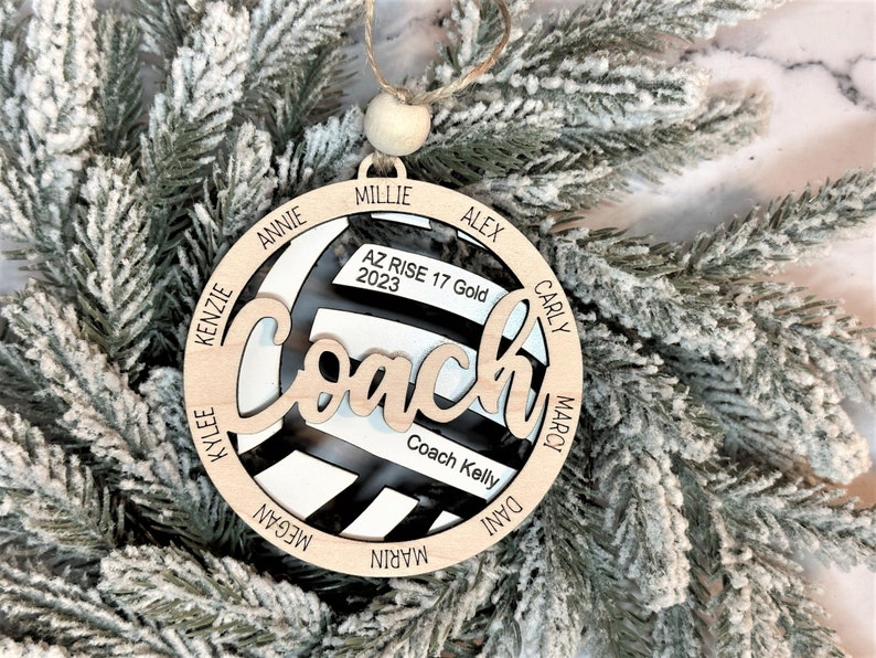 Custom coach volleyball ornament comes customized with the team name, year and up to 16 player names.  Double layered laser engraved ornament measures approx. 3.5" in diameter and comes with decorative bead and twine.