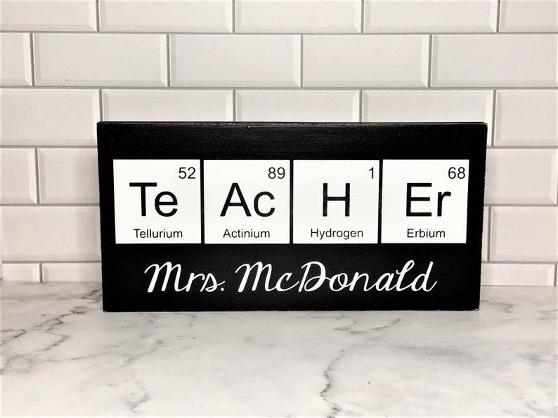Teacher desk name plate for your best science teacher!  Chemistry teacher, Biology teacher or principal.  This custom wood sign measures approx. 5 1/4"x11" and states:

TeAcHEr
Teacher's Name