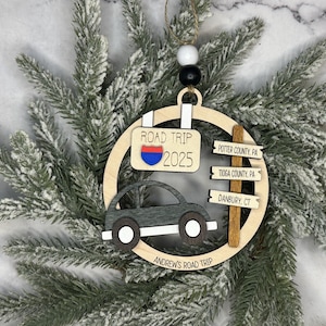 Add a touch of charm to your Christmas tree with our laser engraved wood road trip ornament. Handcrafted with love, this unique piece captures the essence of adventure. Perfect for travel enthusiasts and wanderlust souls! A wonderful gift for anyone who loves hitting the open road. We can add up to 7 locations on this ornament to customize this to your favorite adventure. Order yours today!