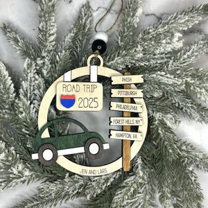 Add a touch of charm to your Christmas tree with our laser engraved wood road trip ornament. Handcrafted with love, this unique piece captures the essence of adventure. Perfect for travel enthusiasts and wanderlust souls! A wonderful gift for anyone who loves hitting the open road. We can add up to 7 locations on this ornament to customize this to your favorite adventure. Order yours today!