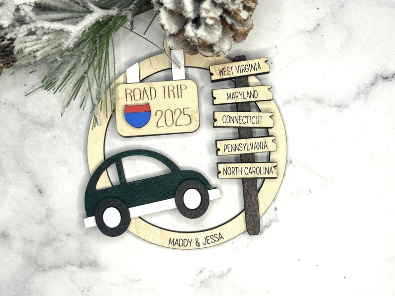 Add a touch of charm to your Christmas tree with our laser engraved wood road trip ornament. Handcrafted with love, this unique piece captures the essence of adventure. Perfect for travel enthusiasts and wanderlust souls! A wonderful gift for anyone who loves hitting the open road. We can add up to 7 locations on this ornament to customize this to your favorite adventure. Order yours today!