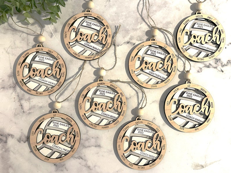 Custom coach volleyball ornament comes customized with the team name, year and up to 16 player names.  Double layered laser engraved ornament measures approx. 3.5" in diameter and comes with decorative bead and twine.