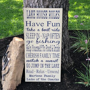 Custom wood sign measures approx. 11 1/4 x 23 inches and states: 

Lake House Rules
Have Fun
Take A Boat Ride
Sleep In - Nap Often
Go Fishing
Help Yourself To Food & Drink
Cherish Family Time
Watch A Sunset
Go Jump In The Lake
Read - Relax - Unwind