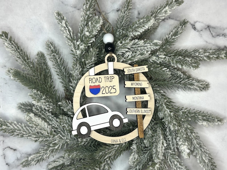 Add a touch of charm to your Christmas tree with our laser engraved wood road trip ornament. Handcrafted with love, this unique piece captures the essence of adventure. Perfect for travel enthusiasts and wanderlust souls! A wonderful gift for anyone who loves hitting the open road. We can add up to 7 locations on this ornament to customize this to your favorite adventure. Order yours today!