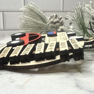 Add a touch of charm to your Christmas tree with our laser engraved wood road trip ornament. Handcrafted with love, this unique piece captures the essence of adventure. Perfect for travel enthusiasts and wanderlust souls! A wonderful gift for anyone who loves hitting the open road. We can add up to 7 locations on this ornament to customize this to your favorite adventure. Order yours today!