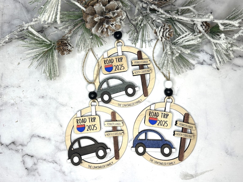 Add a touch of charm to your Christmas tree with our laser engraved wood road trip ornament. Handcrafted with love, this unique piece captures the essence of adventure. Perfect for travel enthusiasts and wanderlust souls! A wonderful gift for anyone who loves hitting the open road. We can add up to 7 locations on this ornament to customize this to your favorite adventure. Order yours today!