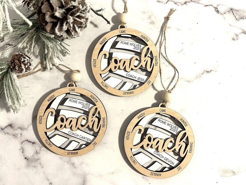 Custom coach volleyball ornament comes customized with the team name, year and up to 16 player names.  Double layered laser engraved ornament measures approx. 3.5" in diameter and comes with decorative bead and twine.