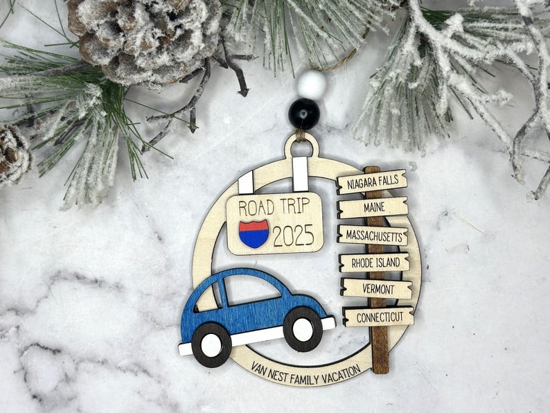Add a touch of charm to your Christmas tree with our laser engraved wood road trip ornament. Handcrafted with love, this unique piece captures the essence of adventure. Perfect for travel enthusiasts and wanderlust souls! A wonderful gift for anyone who loves hitting the open road. We can add up to 7 locations on this ornament to customize this to your favorite adventure. Order yours today!