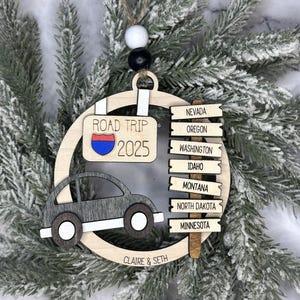 Add a touch of charm to your Christmas tree with our laser engraved wood road trip ornament. Handcrafted with love, this unique piece captures the essence of adventure. Perfect for travel enthusiasts and wanderlust souls! A wonderful gift for anyone who loves hitting the open road. We can add up to 7 locations on this ornament to customize this to your favorite adventure. Order yours today!