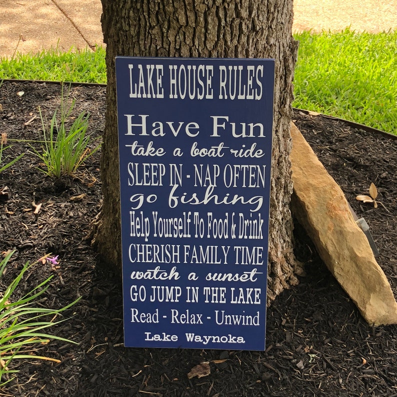 Custom wood sign measures approx. 11 1/4 x 23 inches and states: 

Lake House Rules
Have Fun
Take A Boat Ride
Sleep In - Nap Often
Go Fishing
Help Yourself To Food & Drink
Cherish Family Time
Watch A Sunset
Go Jump In The Lake
Read - Relax - Unwind