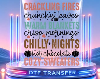 May include: A DTF transfer sheet featuring autumn-themed text in various fonts and colors, including CRACKLING FIRES, crunchy leaves, WARM BLANKETS, crisp mornings, CHILLY NIGHTS, hot chocolate, and COZY SWEATERS with pumpkin icons.