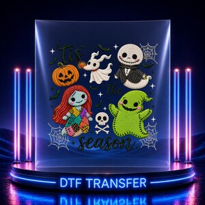 May include: A DTF transfer sheet featuring the text 'Tis the season' surrounded by embroidered-style illustrations of a jack-o'-lantern, a white ghost dog, a skeleton character in a suit, a ragdoll character, a green monster, and a skull.